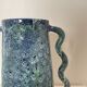 Blue-green ceramic vase with abstract wavy handles