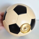 Vintage cigarette dispenser in the shape of a football.