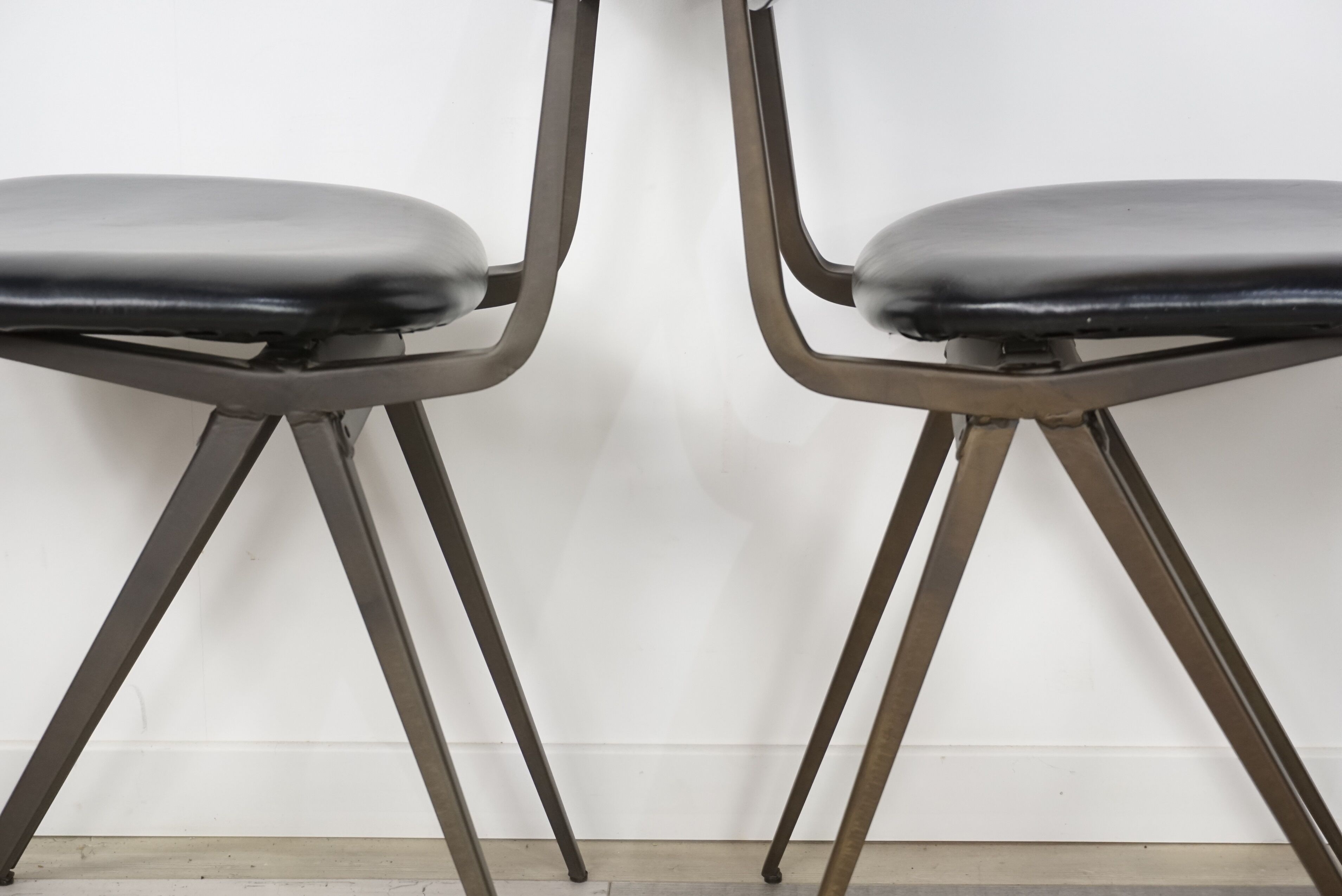 Pair of industrial style chairs in metal and faux black leather