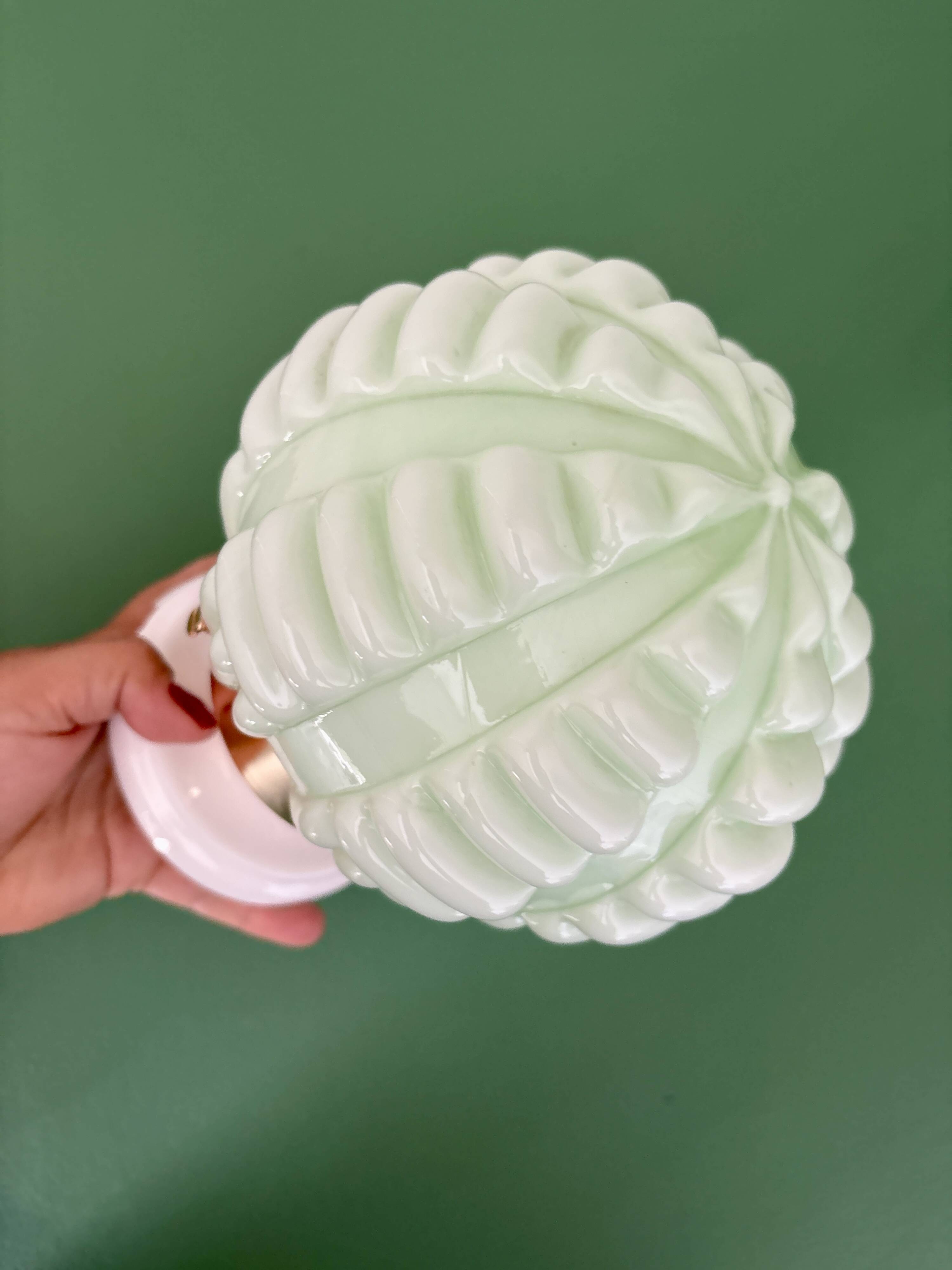 Vintage Art Deco globe wall light in pale green opaline.