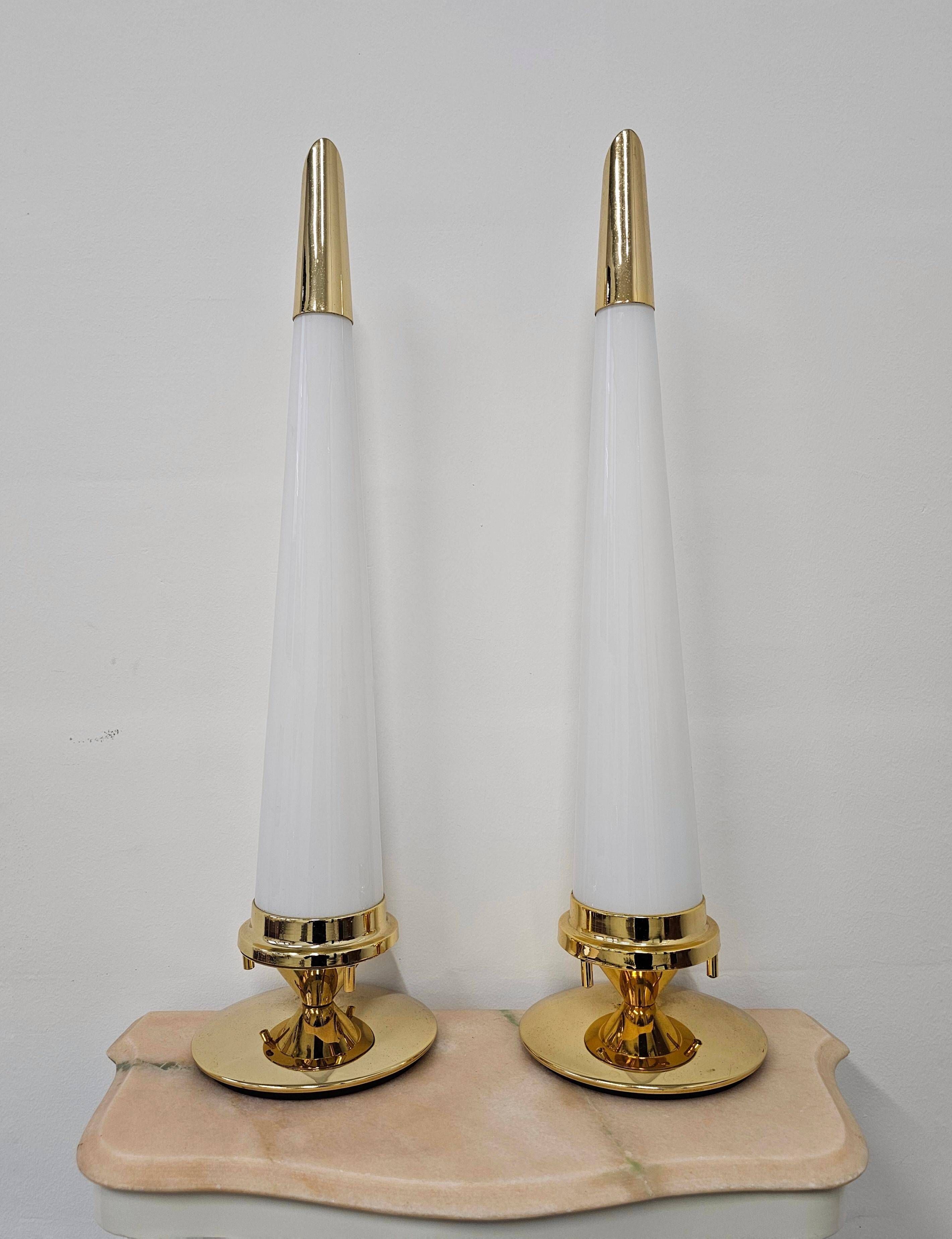 Pair of Hollywood Regency table lamps in brass with glass shades.