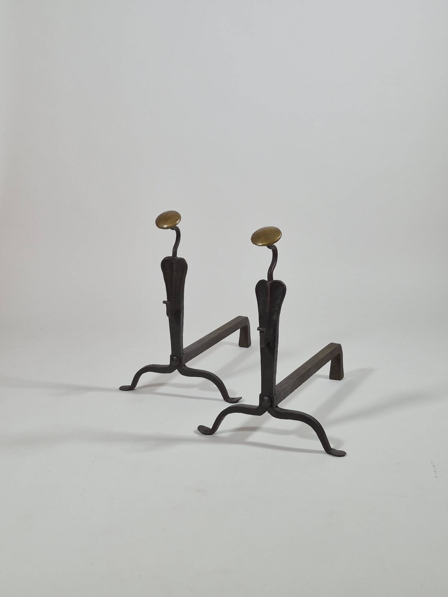 Pair of handforged metal and brass andirons