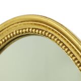 Miroir ovale doré de style Hollywood Regency