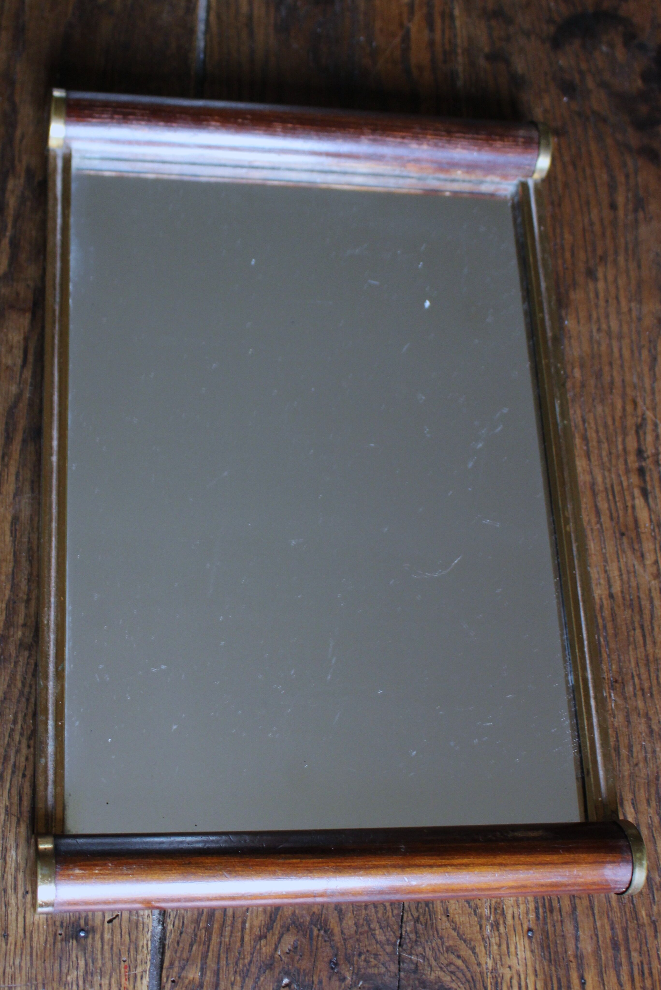 Rectangular mirror tray with wooden handles and gilding.
