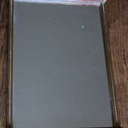 Rectangular mirror tray with wooden handles and gilding.