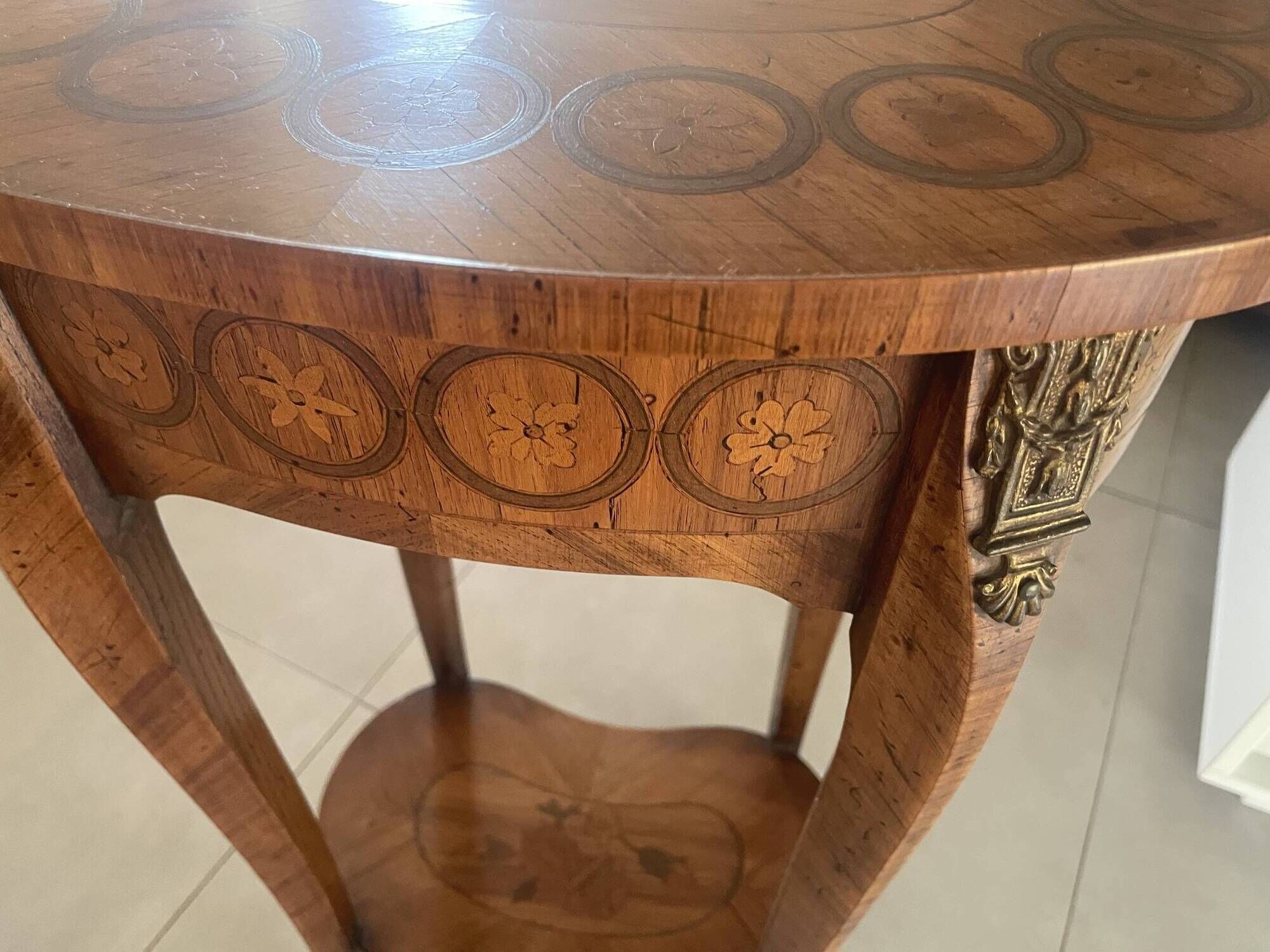 Oval bedside table from the Transition period in marquetry and bronze.