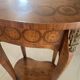 Oval bedside table from the Transition period in marquetry and bronze.