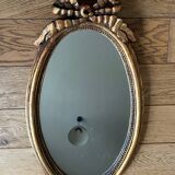 Old oval gilded stucco mirror