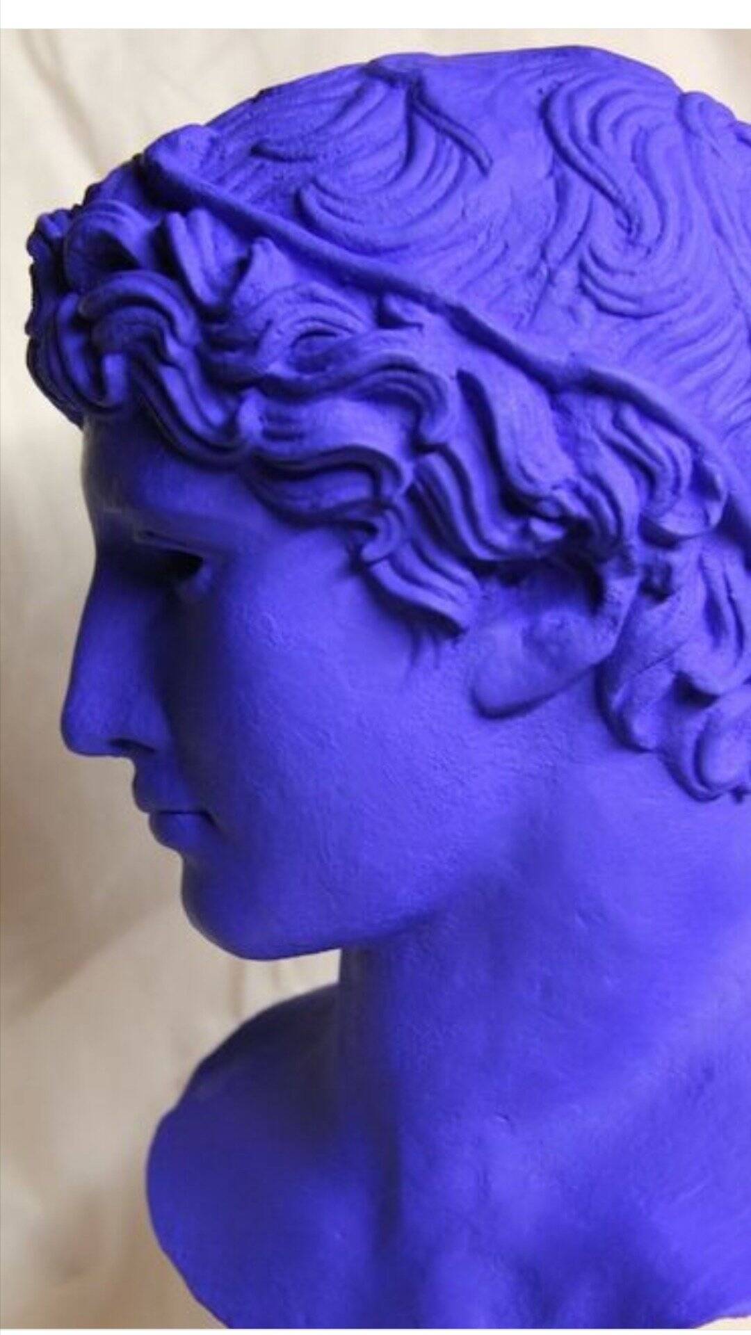 Large bust of a Greek Roman Apollo on a pedestal