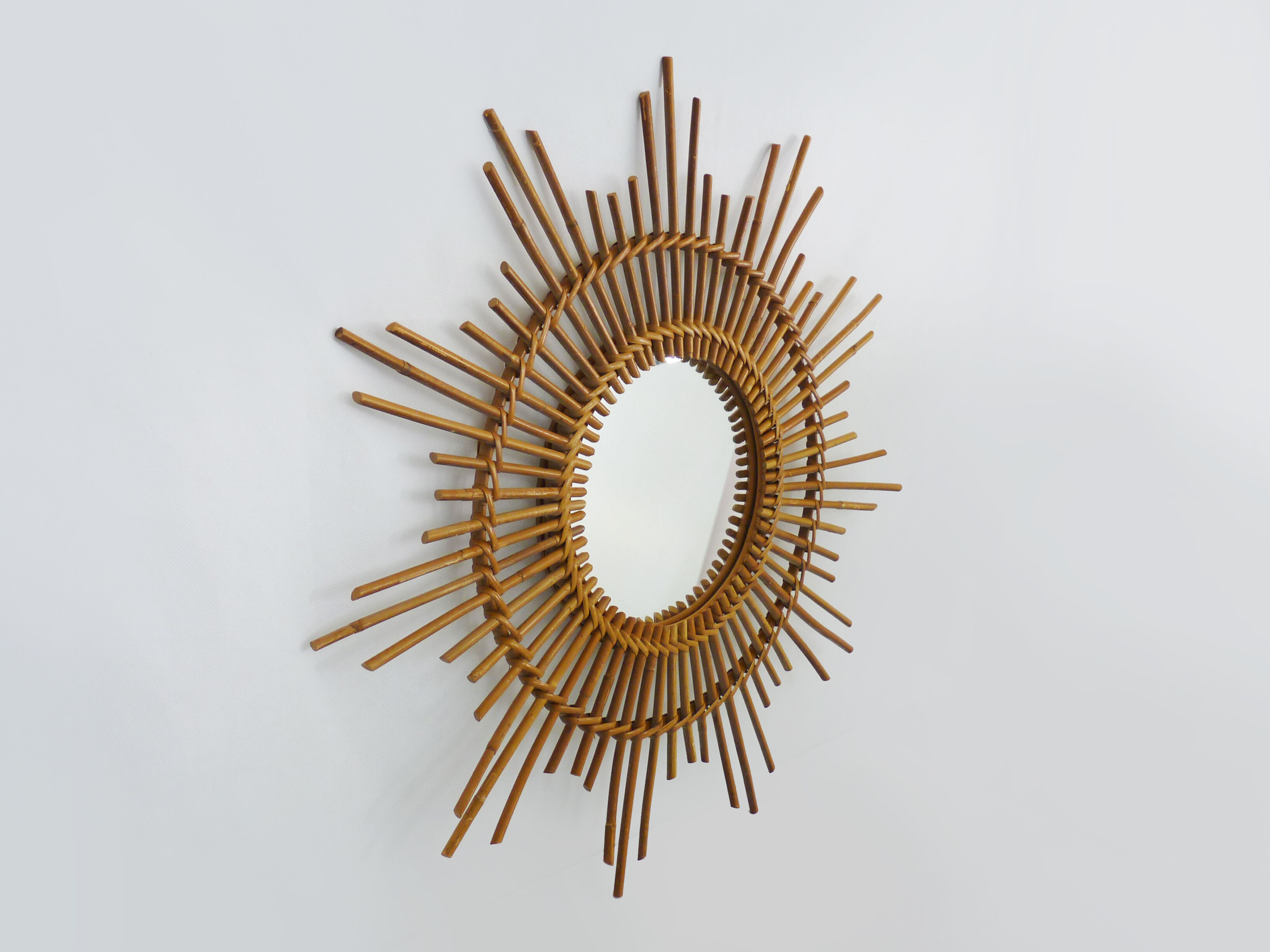 Vintage rattan sun mirror. Year 60