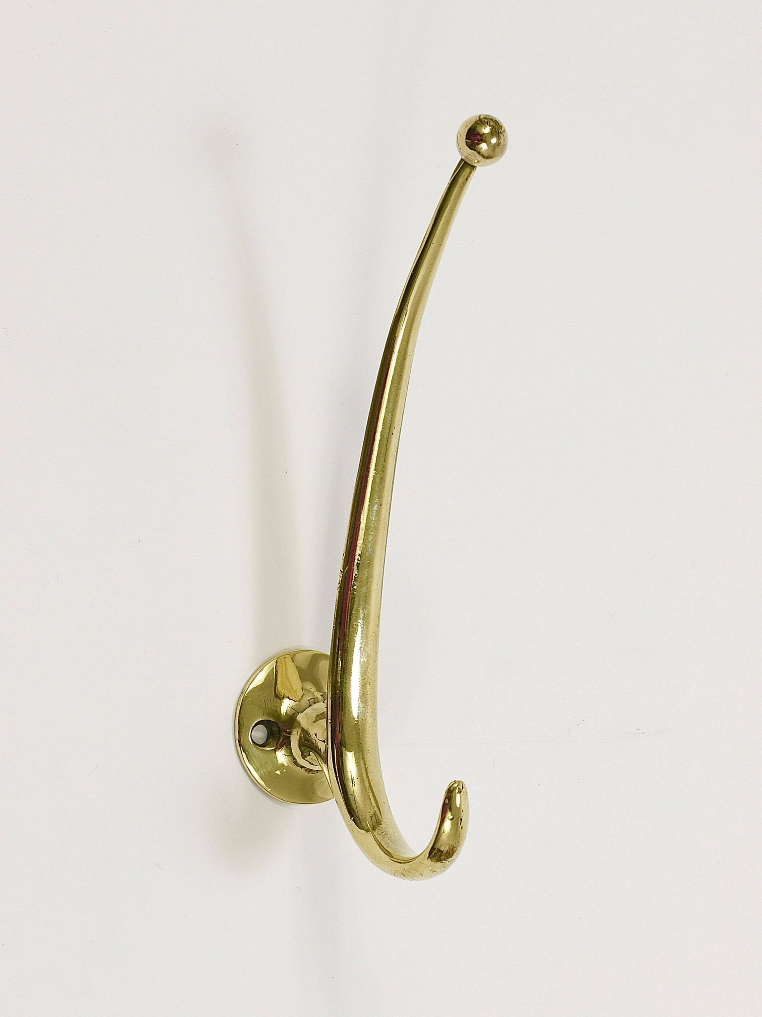Two curved wall coat racks in brass by Franz Hagenauer, Vienna, mid-20th century, 1950s.