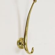Two curved wall coat racks in brass by Franz Hagenauer, Vienna, mid-20th century, 1950s.