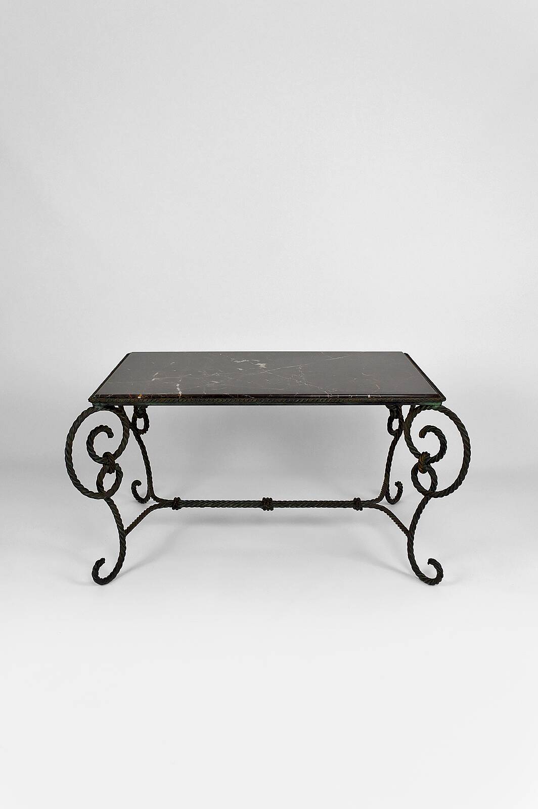 Coffee table in patinated wrought iron and black marble, circa 1940