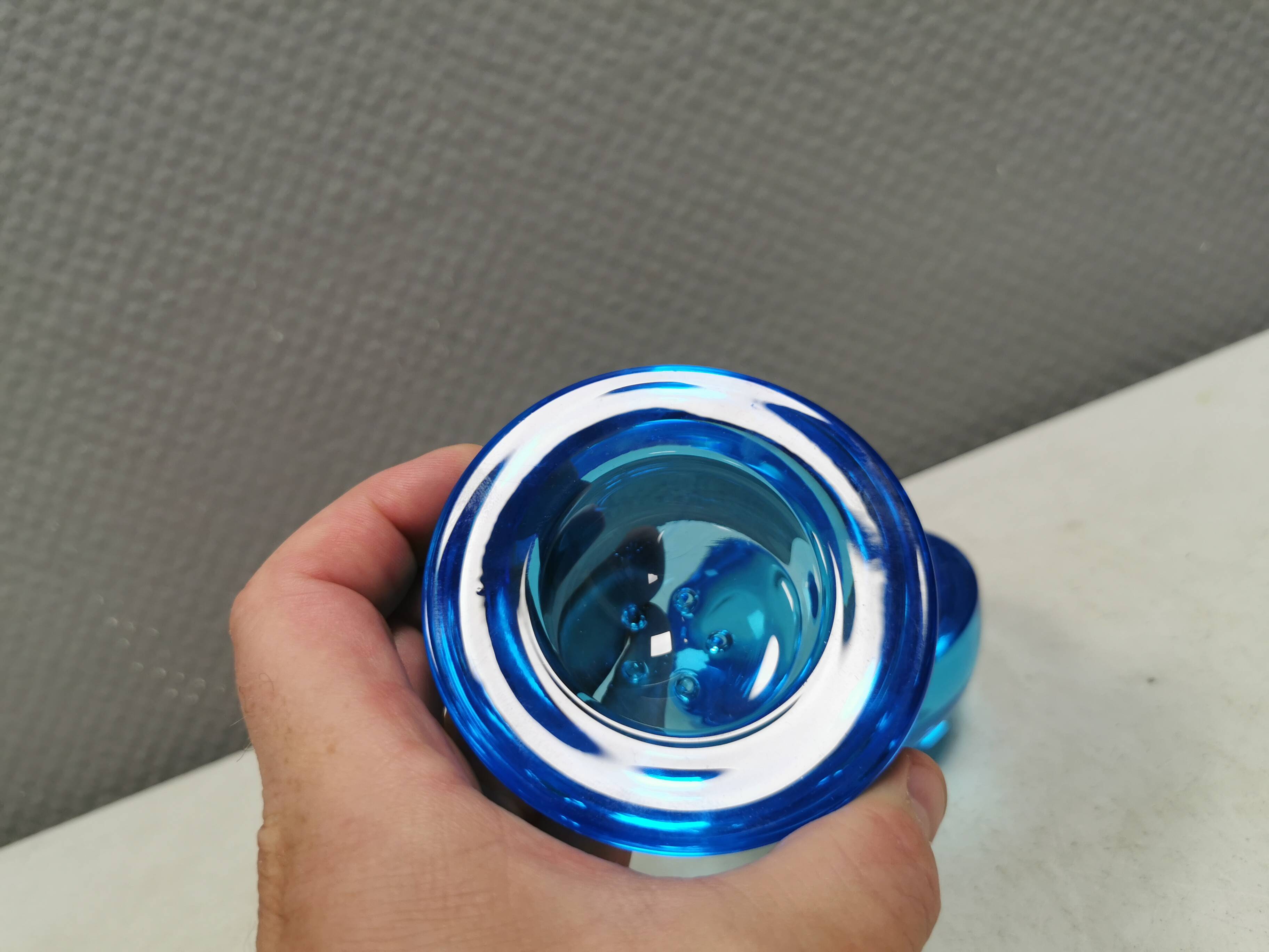 A set of iitalla candle holders in blue transparent glass.