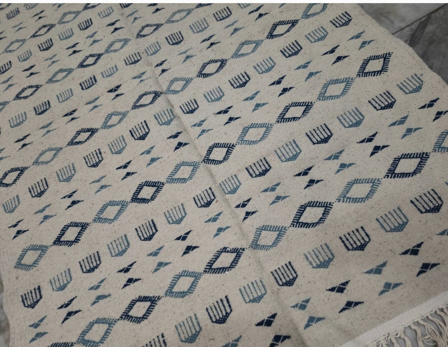 Handmade white and blue rug made of natural wool