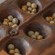 Decorative Mancala game board made of hand-carved wood, Africa, mid-20th century.