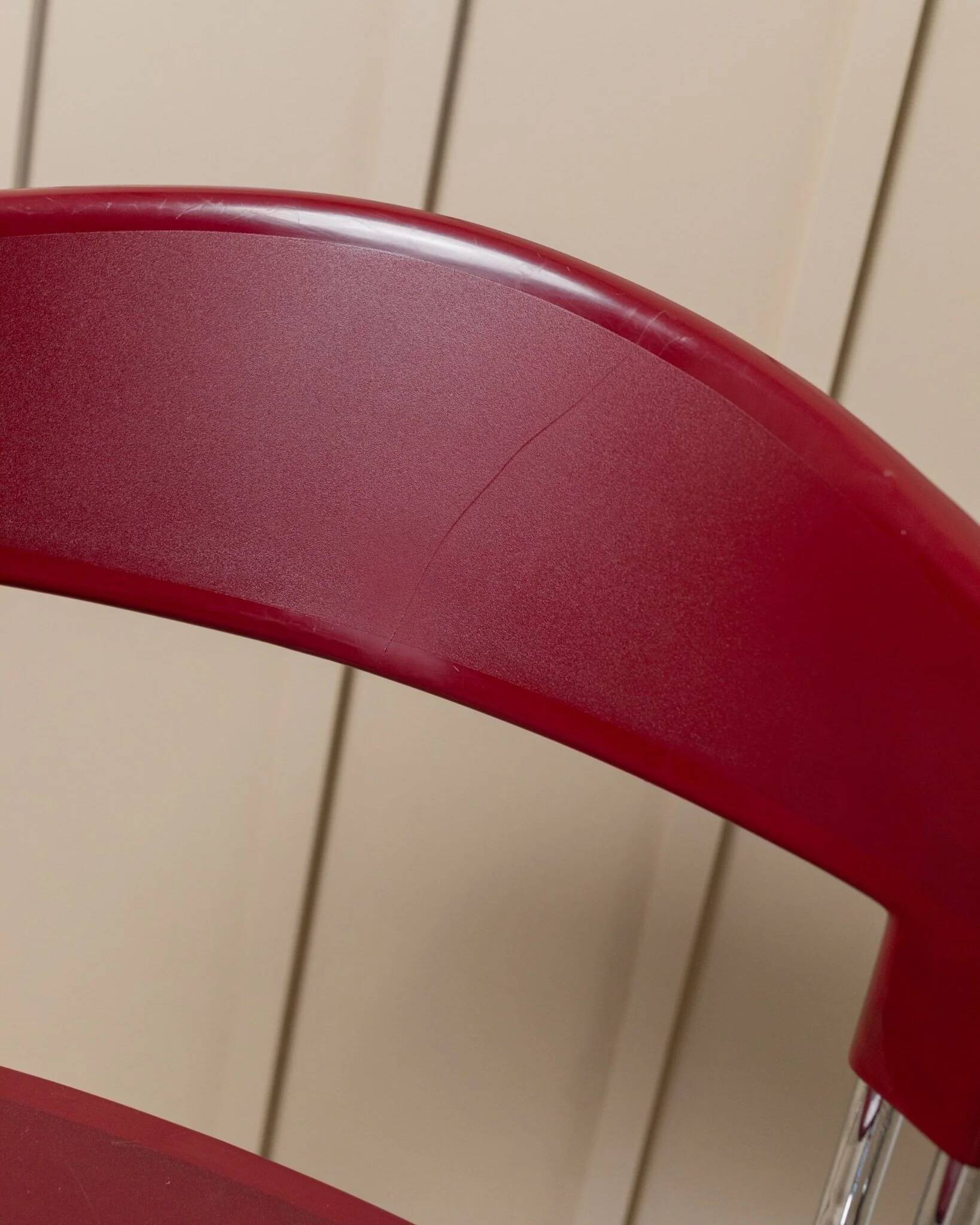 Red plastic-seat stacking chair with chrome frame by Paolo Favaretto for Assisa (Italy 1986) – vintage design