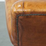 Fauteuil ancien en cuir de mouton couleur cognac