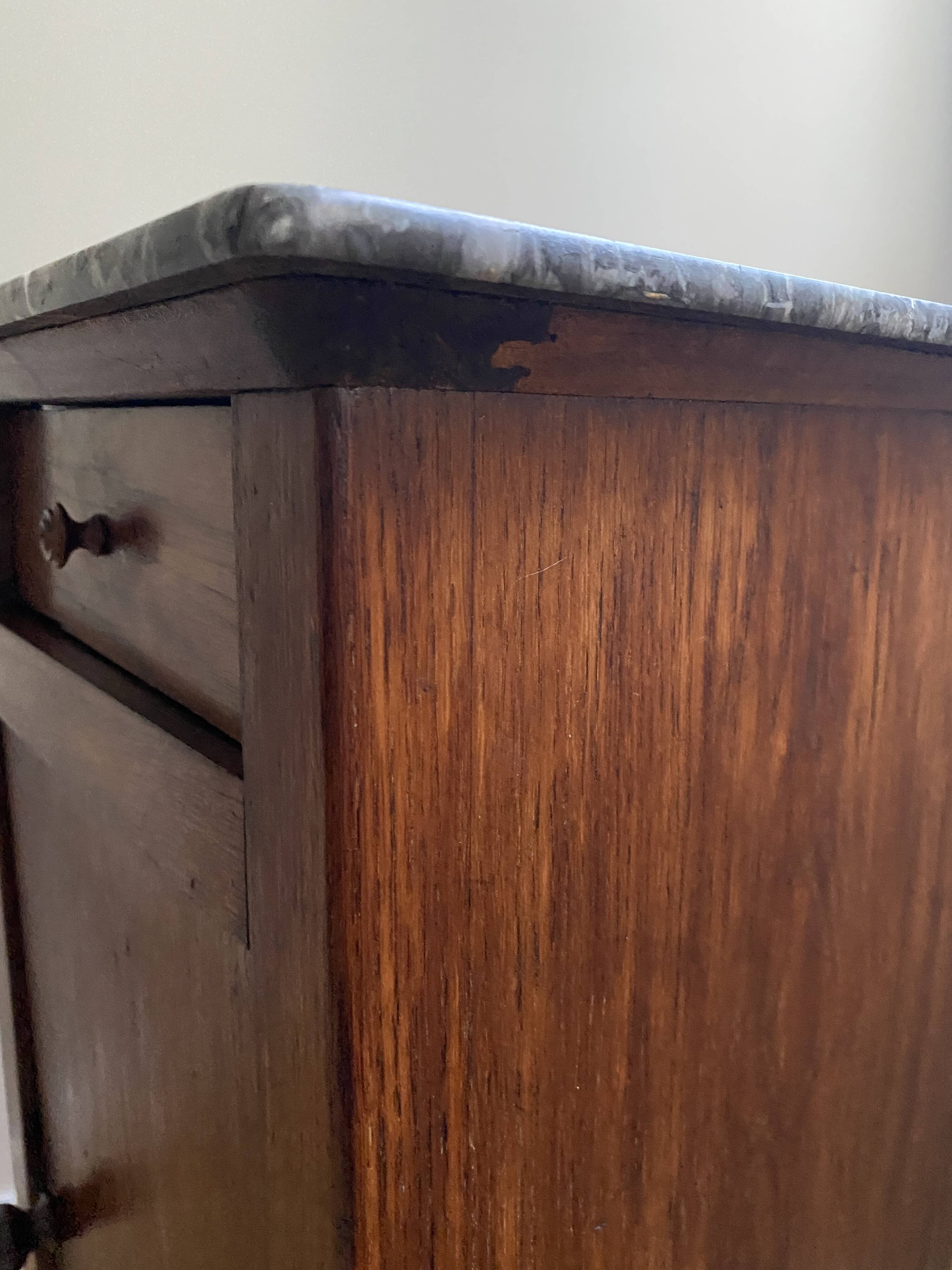 Vintage bedside table in the shape of a wooden column and a gray marble top