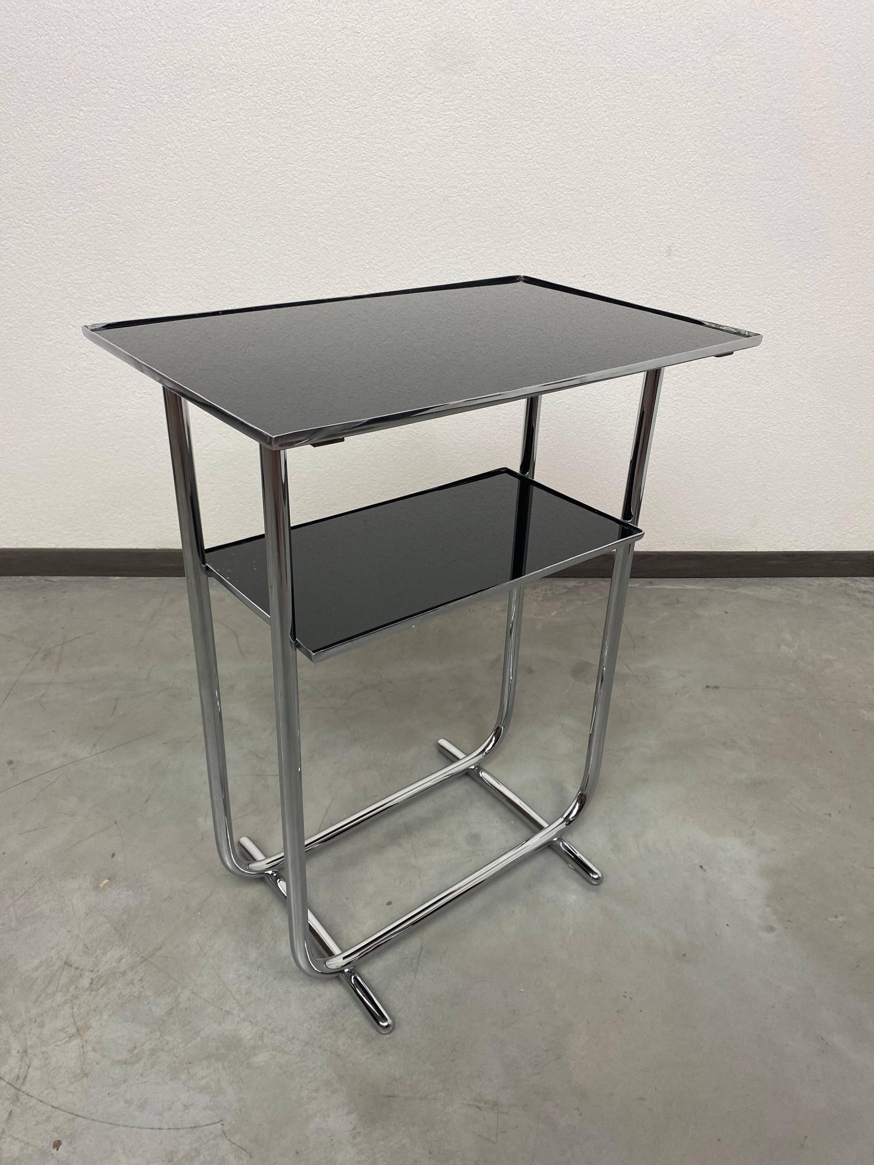Bauhaus side table with a black glass top
