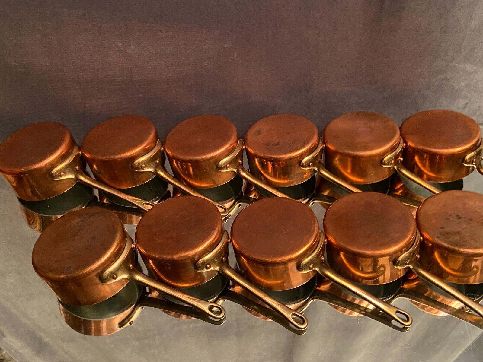 Suite of 12 tinned copper pans