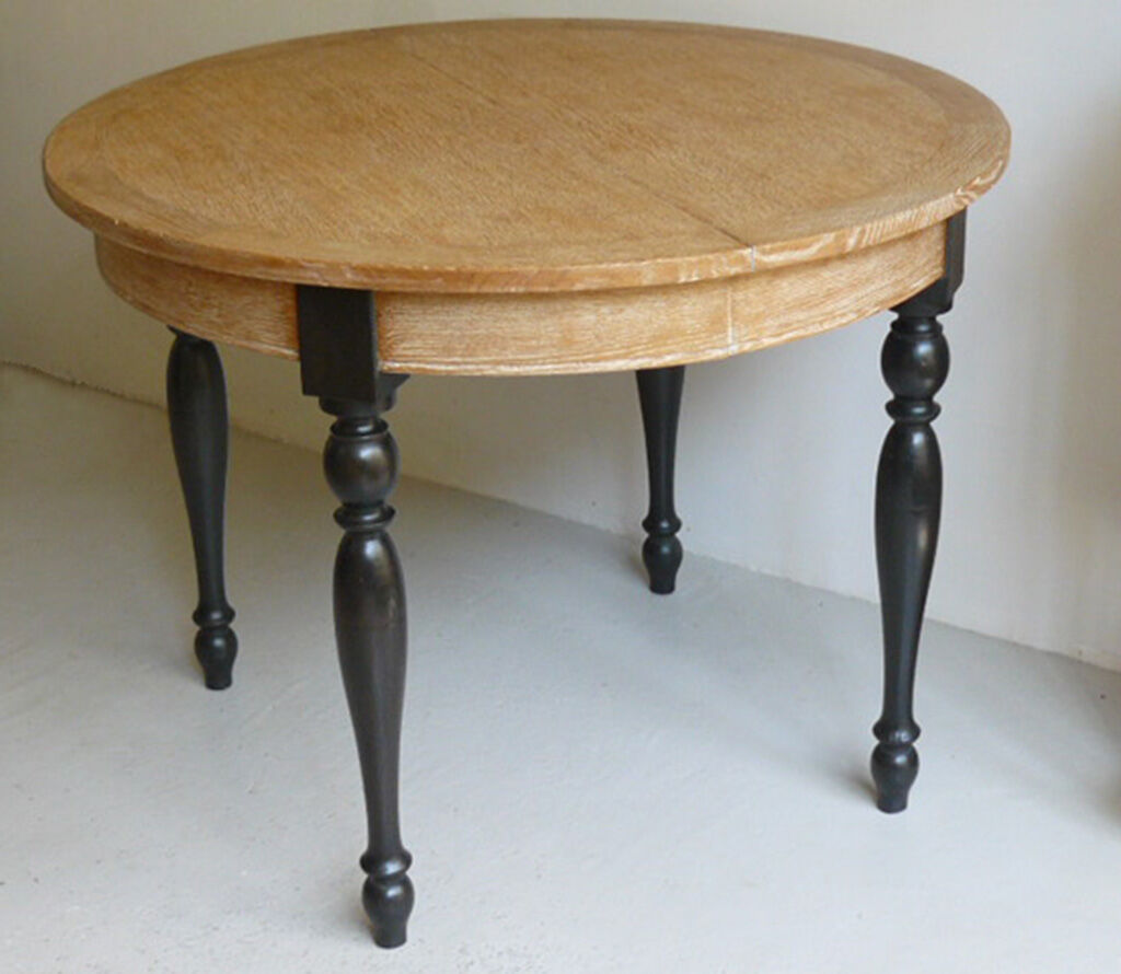 Round table in coloured cerused oak, waxed coloured feet