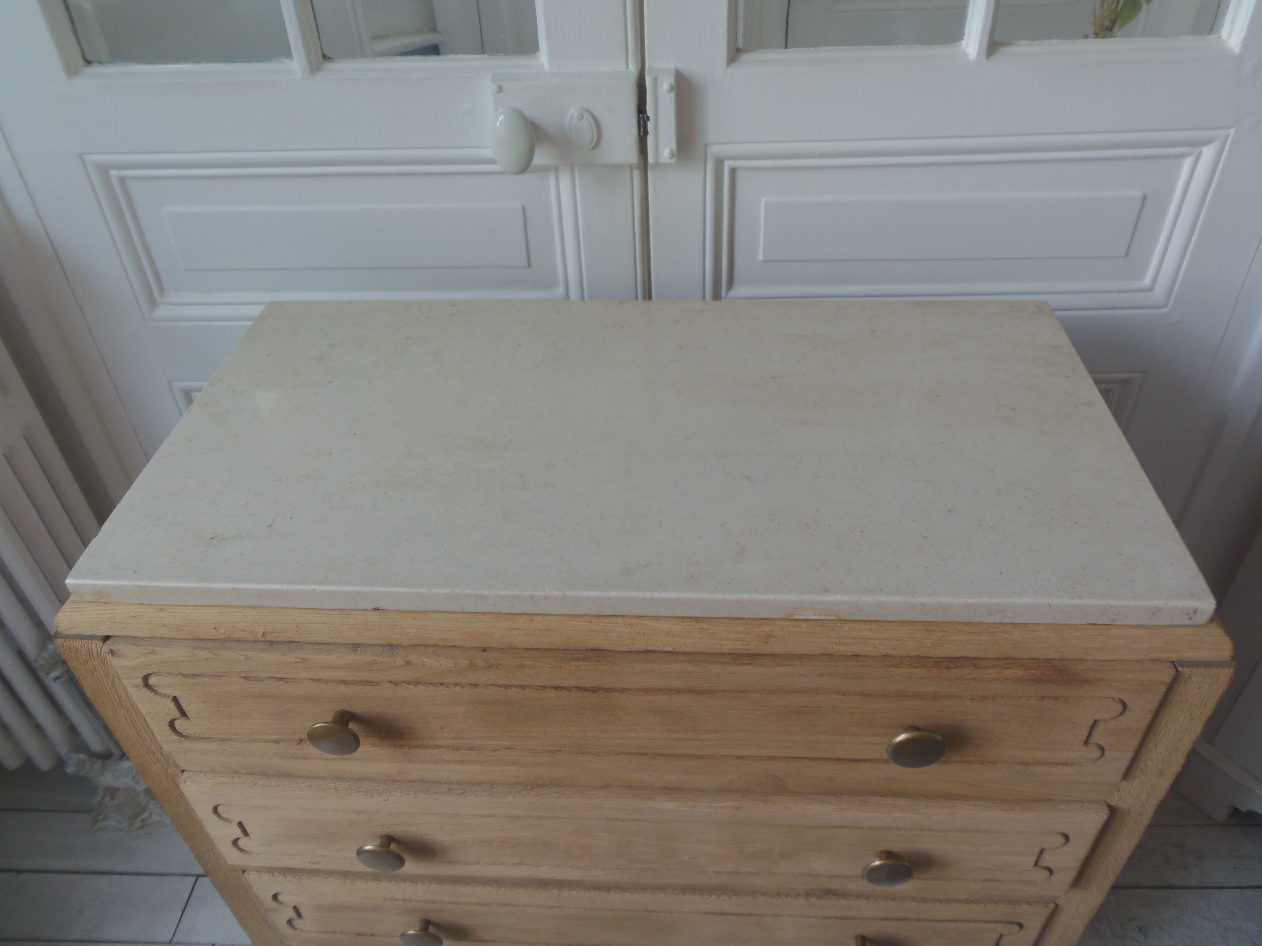Vintage oak chest of drawers, a travertine plate laid for tray.
