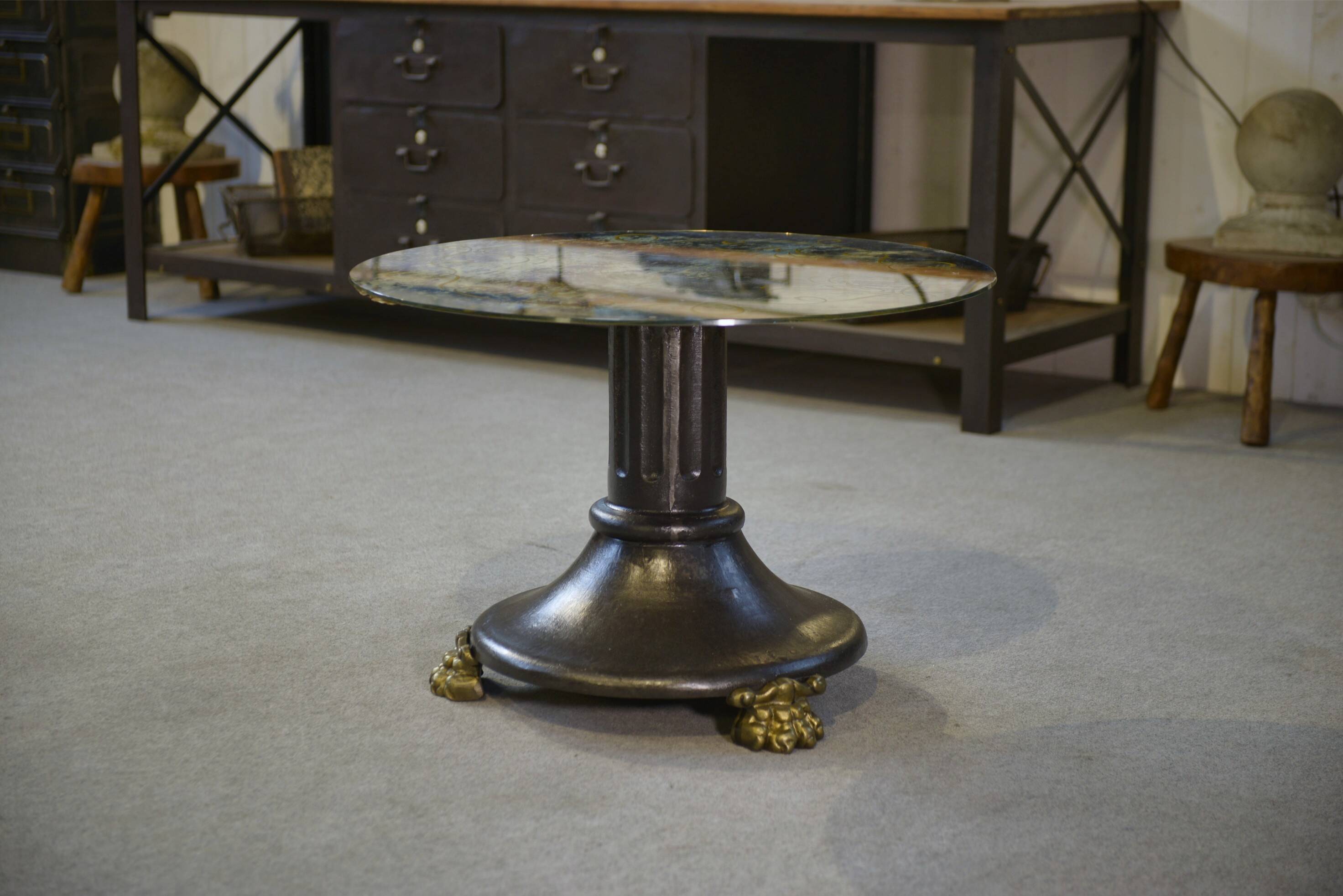 Neo-classical cast iron and glass eglomisé coffee table from the 1940s.