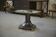 Neo-classical cast iron and glass eglomisé coffee table from the 1940s.