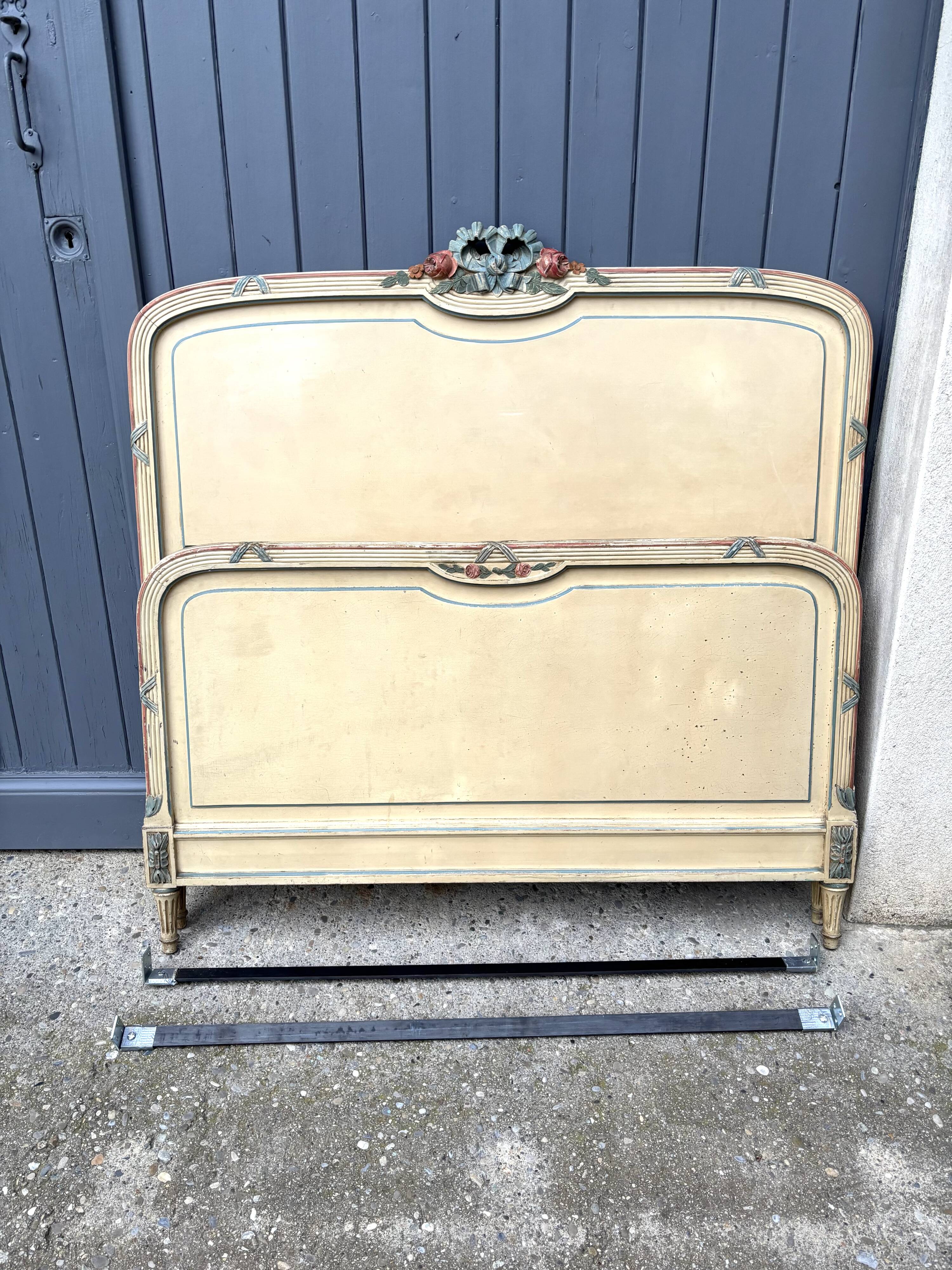 Carved and painted wooden bed