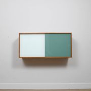 A vintage mid century wall hung bookcase/cabinet with glass sliding doors