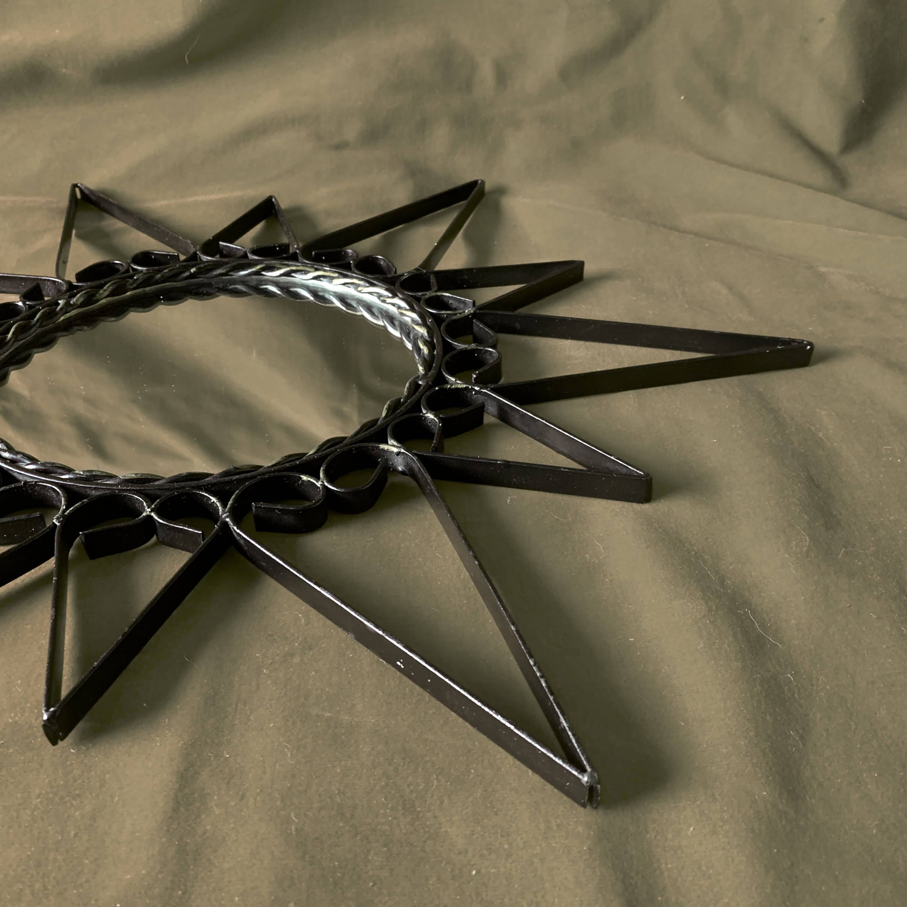 Old wrought metal sun mirror