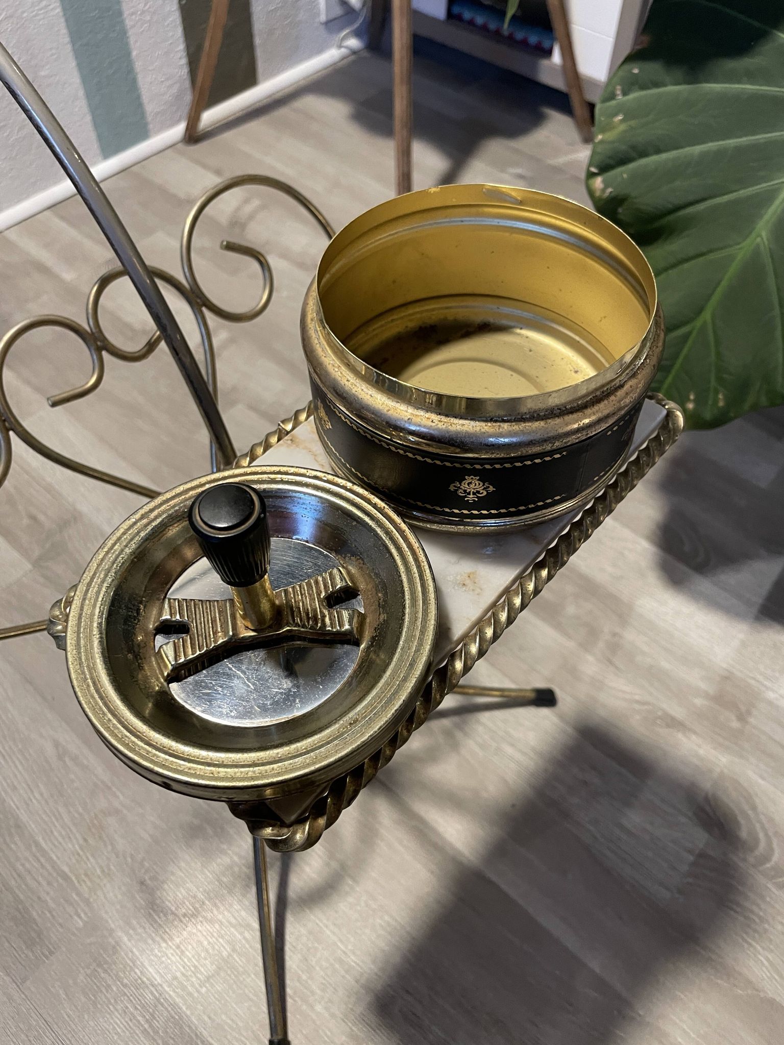 Gold wrought iron ashtray on legs with magazine rack and marbled shelf