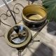 Gold wrought iron ashtray on legs with magazine rack and marbled shelf