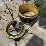 Gold wrought iron ashtray on legs with magazine rack and marbled shelf