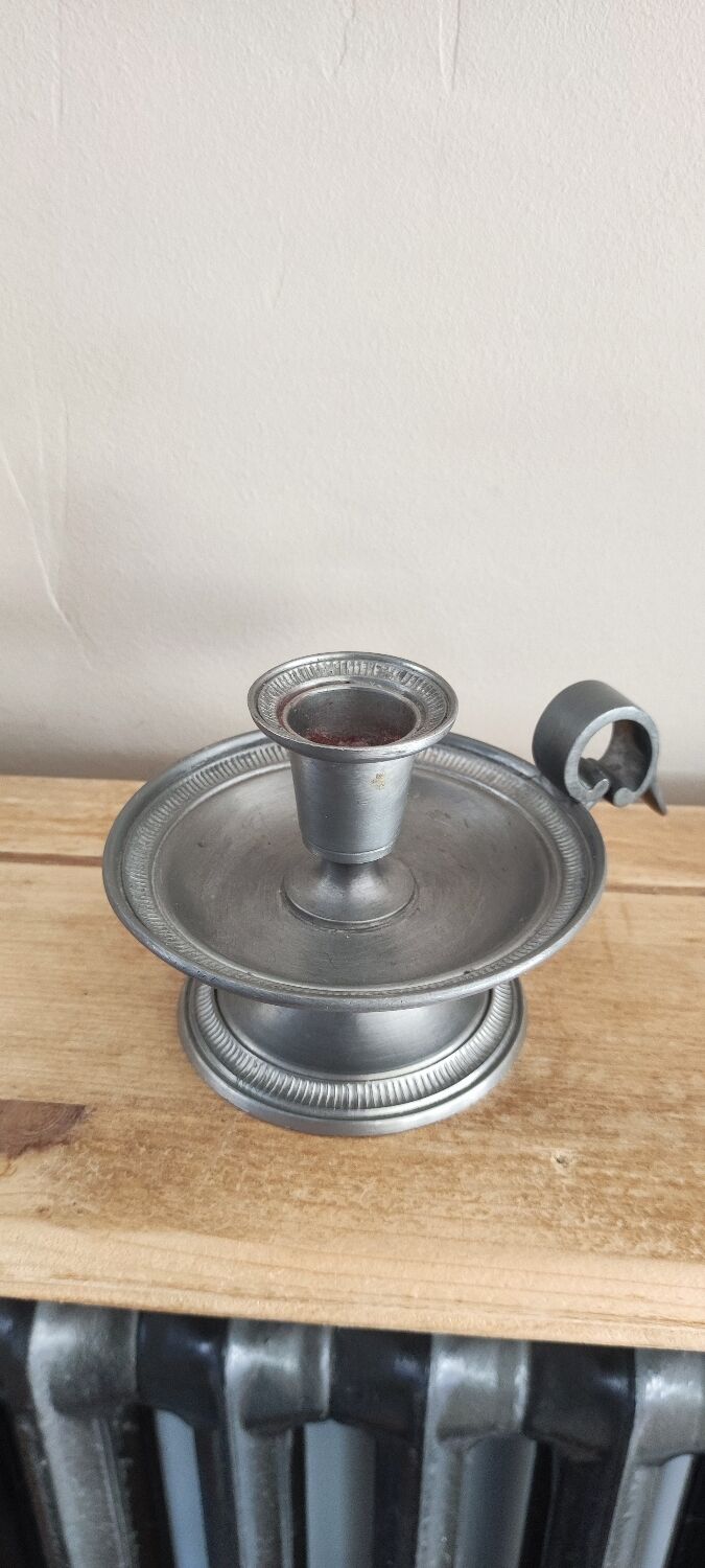 Tin hand candle holder.