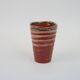 Small orange glazed ceramic cup