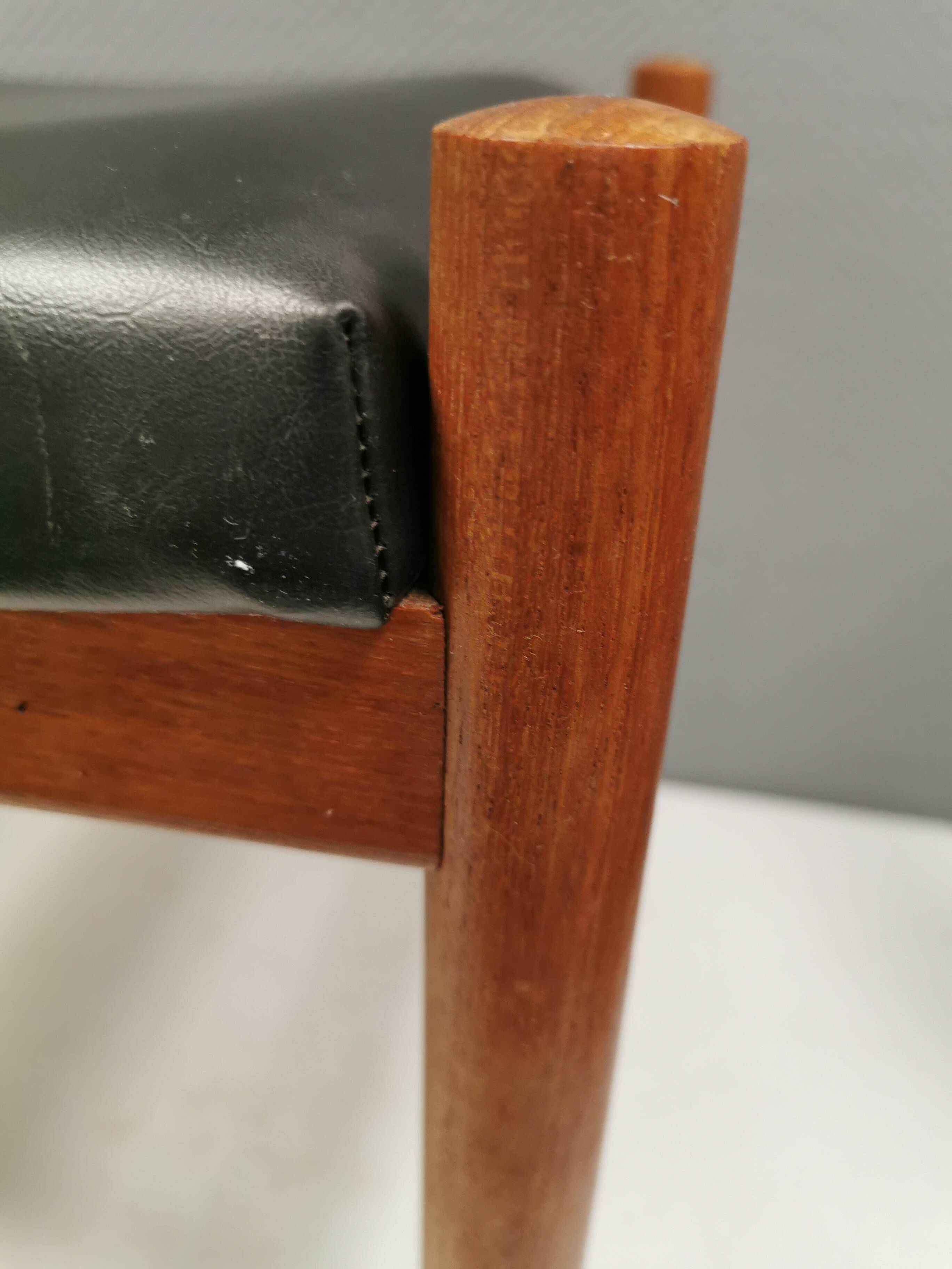 Danish designed footstool in teak wood and black skai “imitation leather”