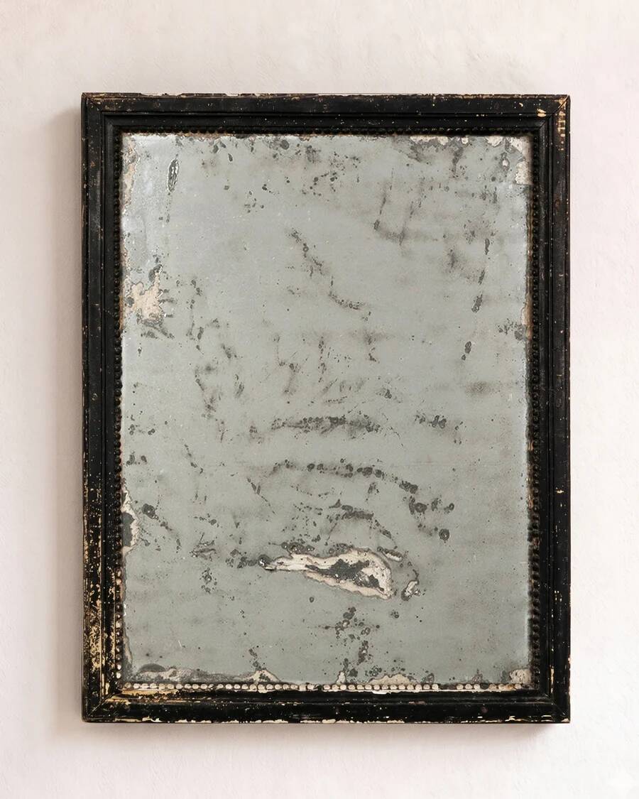 Antique French mirror from the late 19th century with a black painted frame.