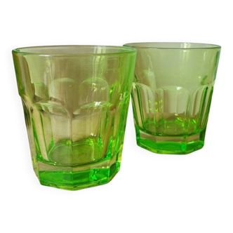 Two fluorescent green water glasses