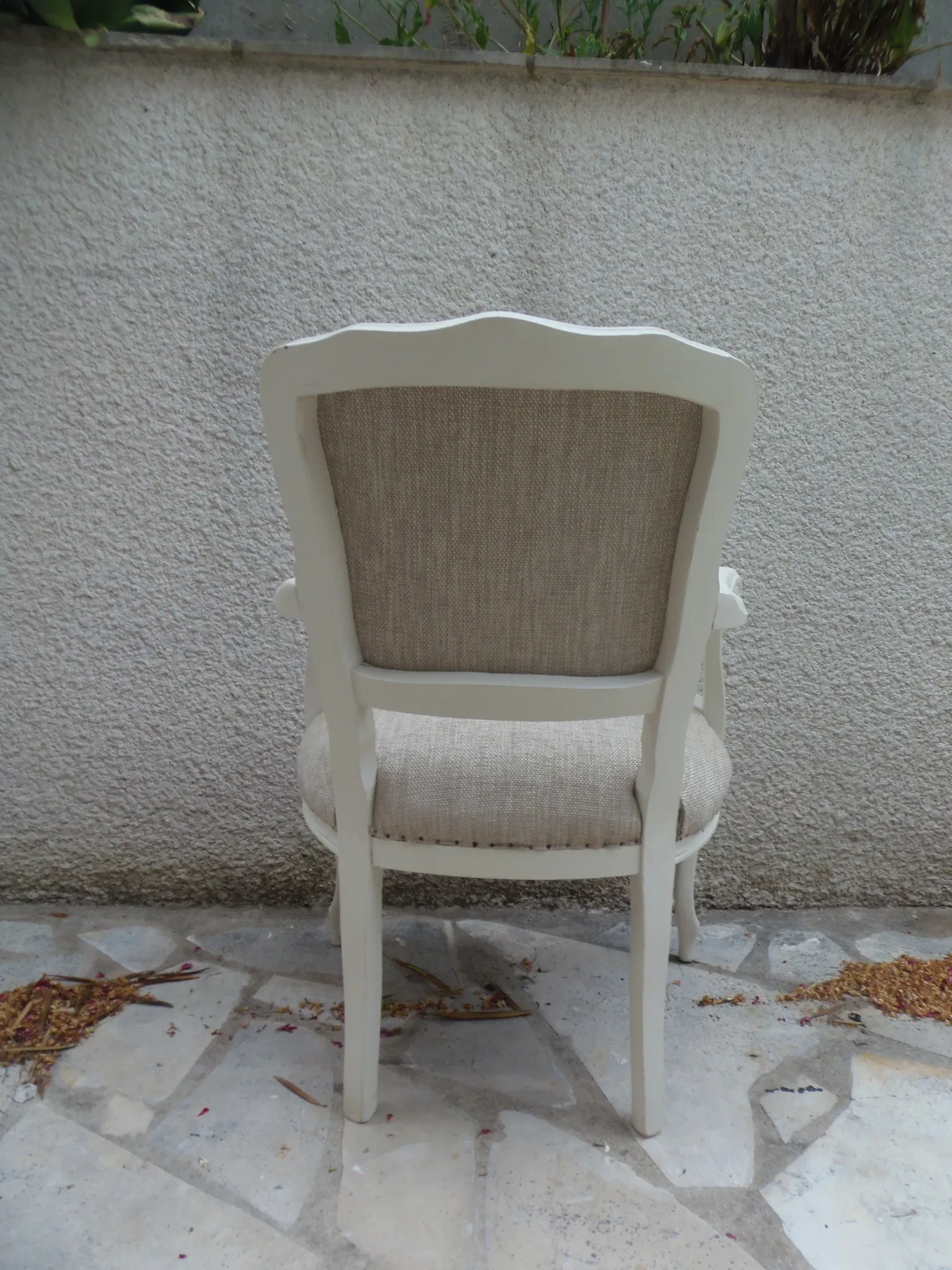 Louis XV style armchair, delicately patinated in a soft beige hue.
