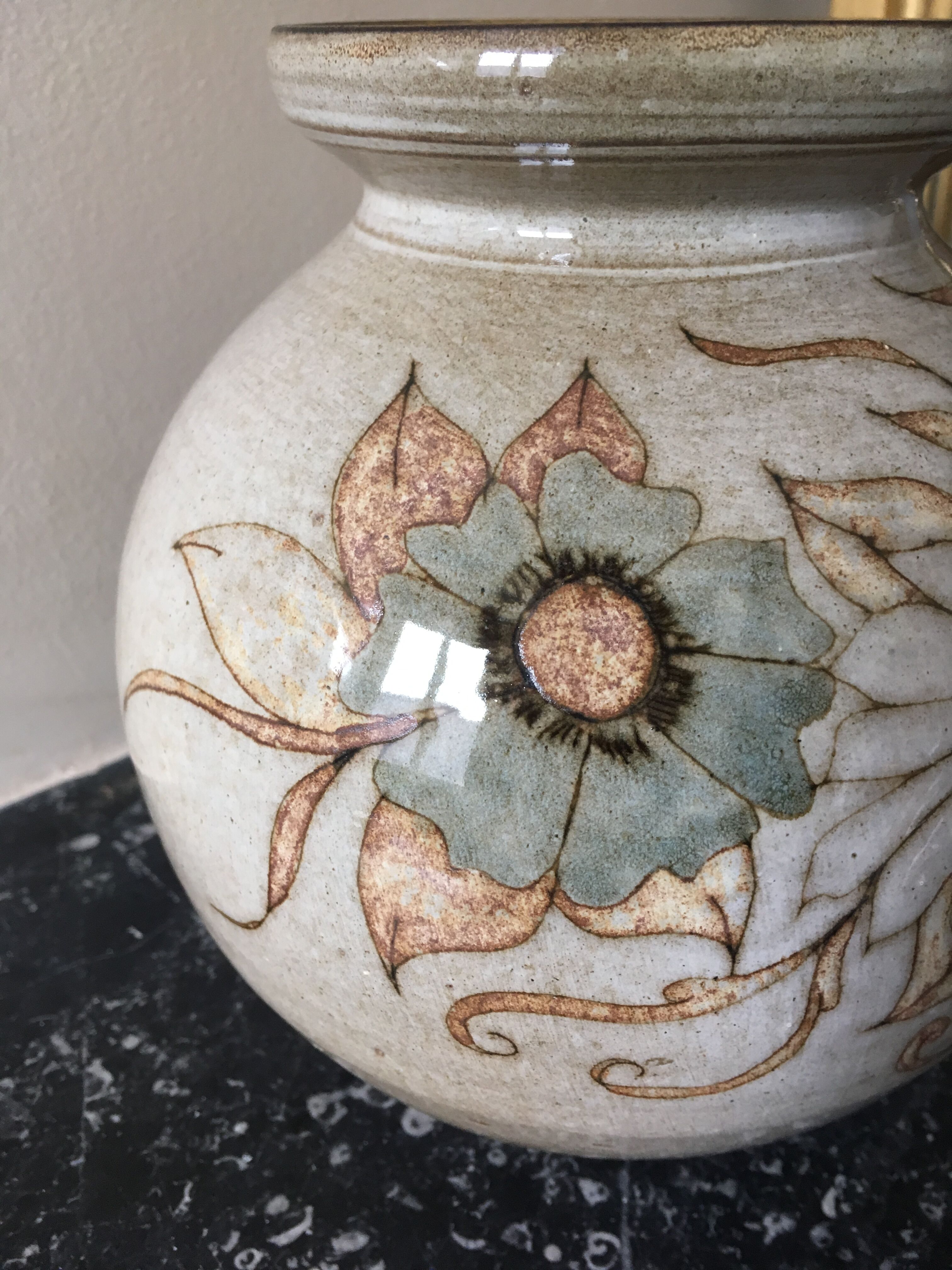 Glazed stoneware ball vase decorated with flowers