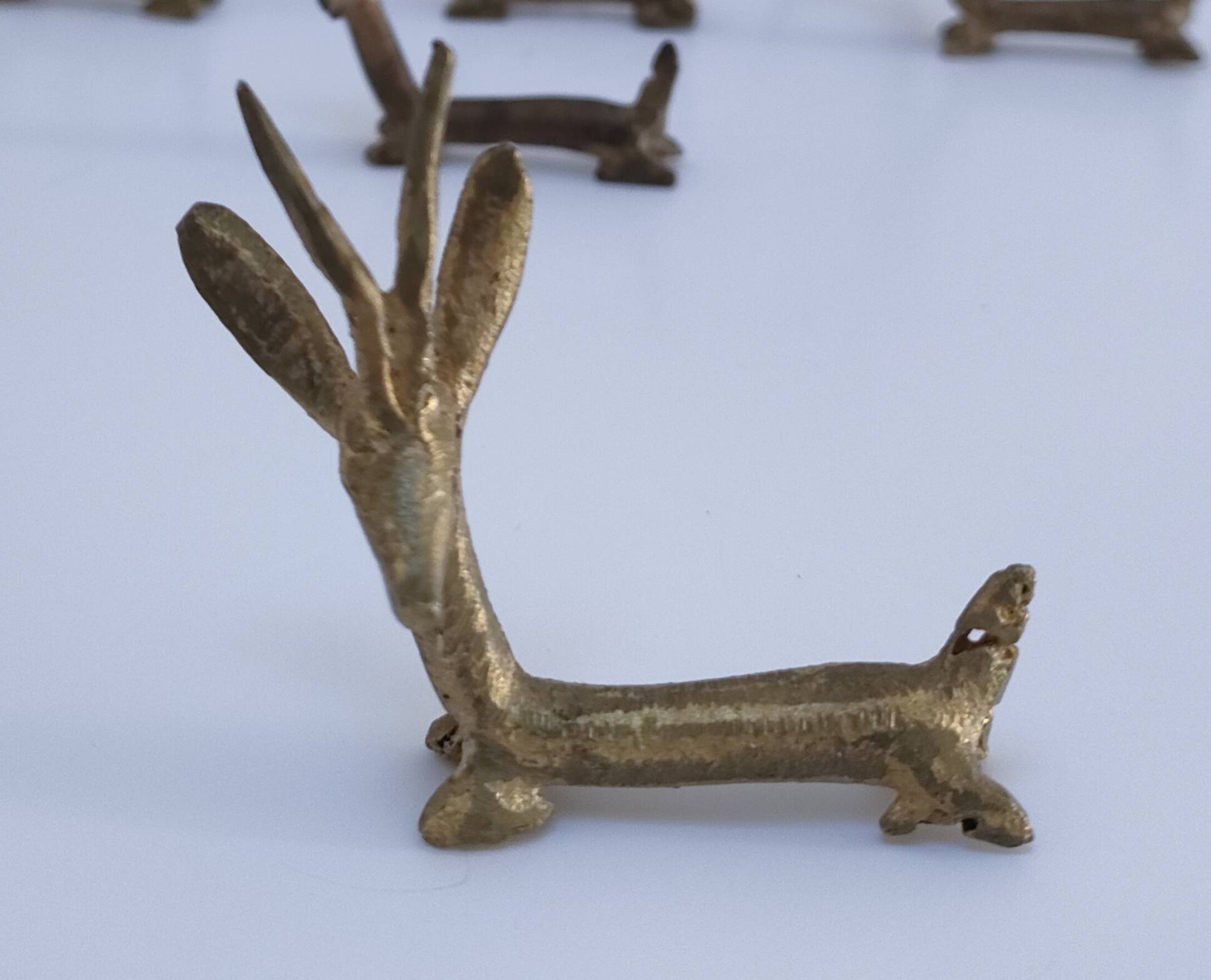 eight vintage brass Gazelle knife rests