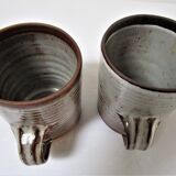 Two enamelled sandstone mugs Roger Jacques handwritten signature