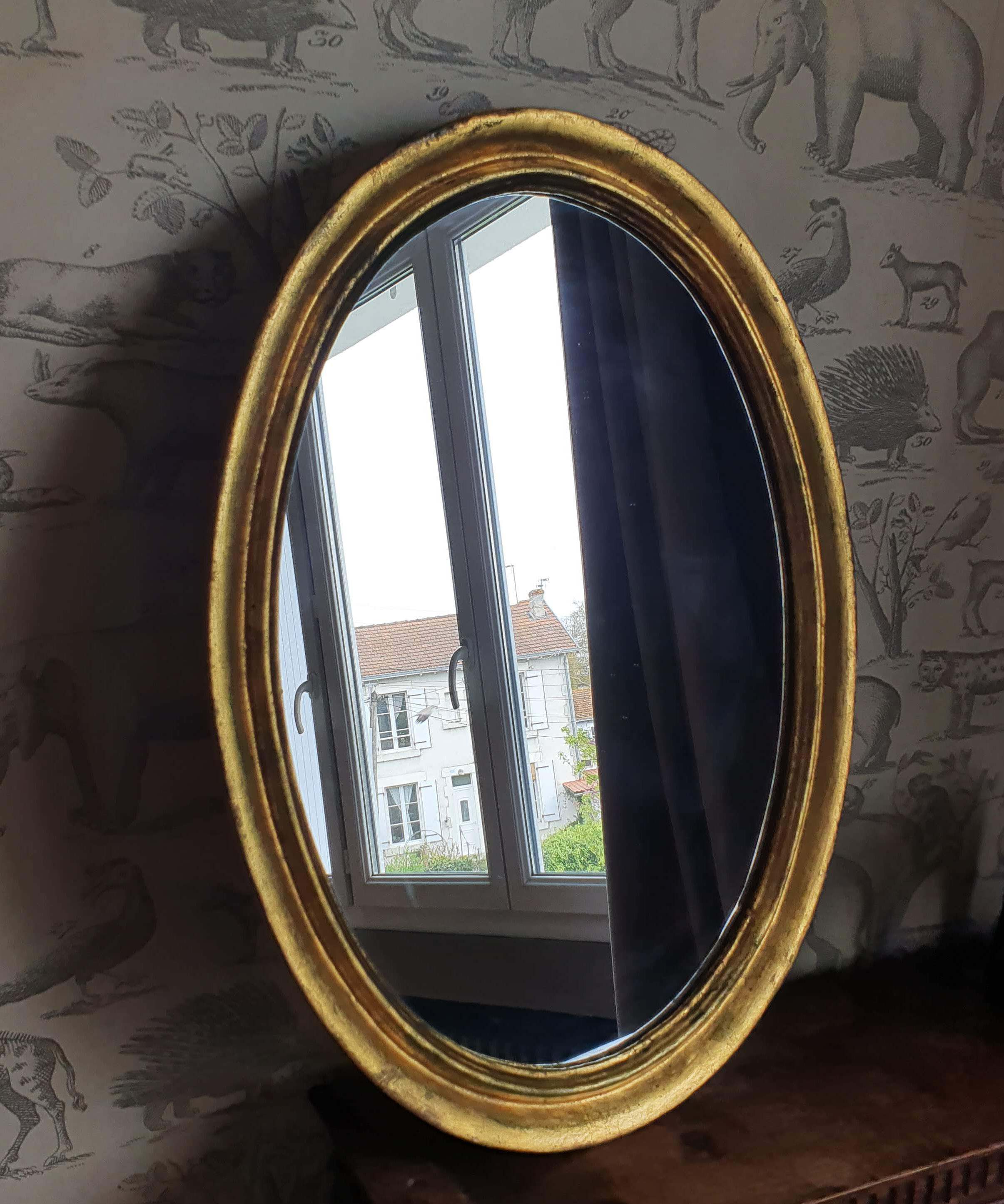 Oval mirror in gilded wood 67X52