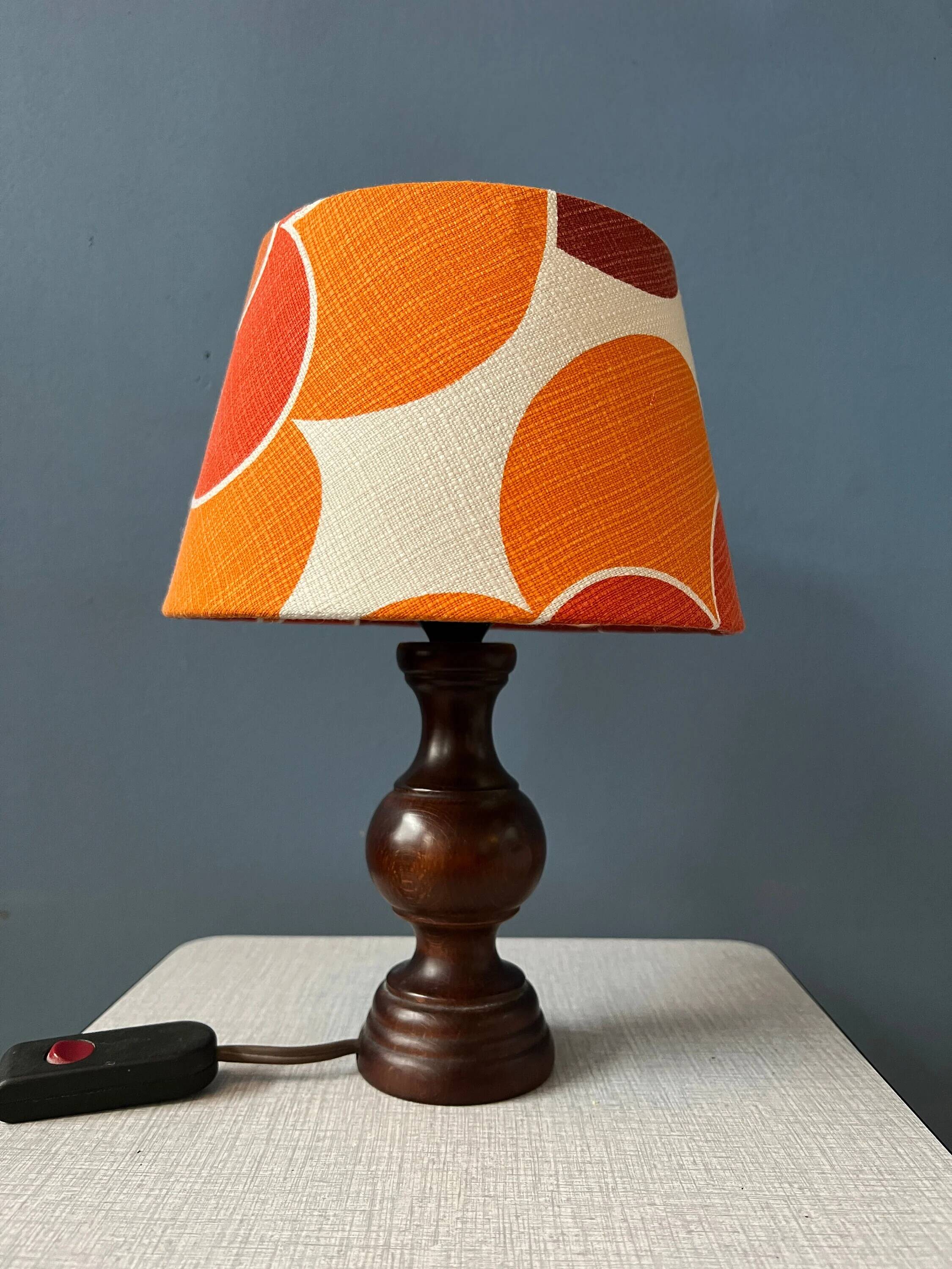 Vintage Space Age table lamp with orange fabric shade.