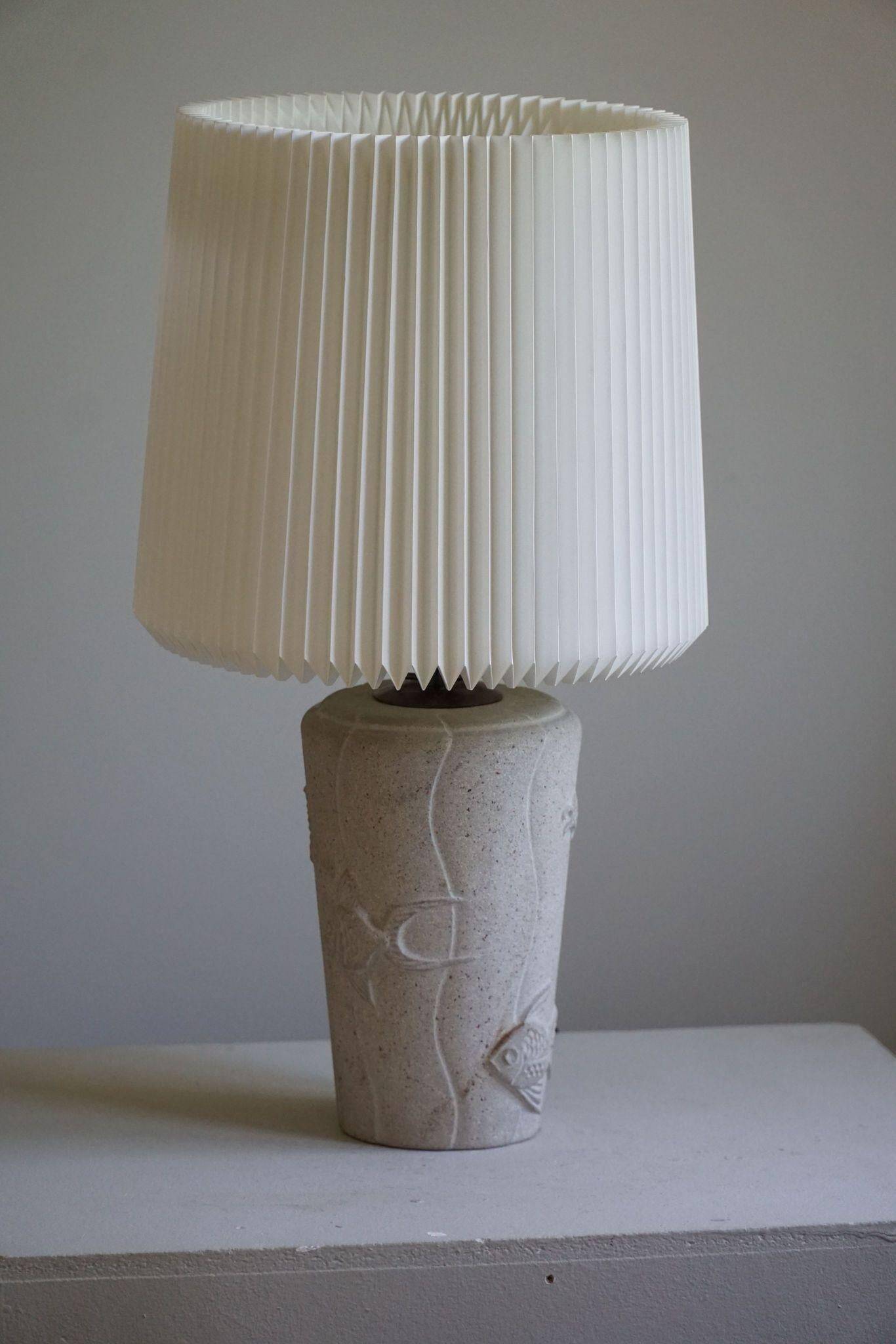 Modern vintage French table lamp, made of stone with fish patterns, 1970s.