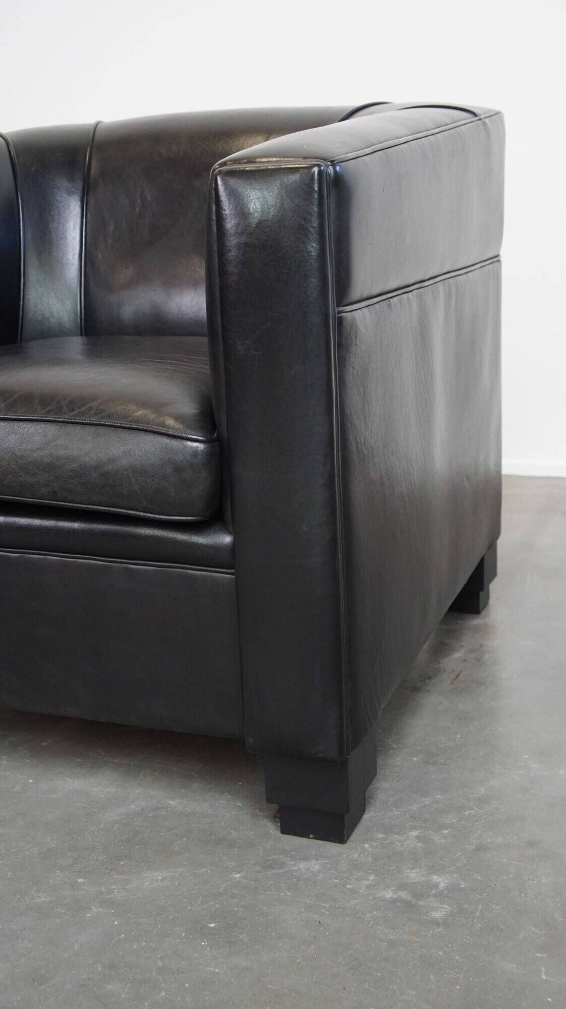 Very comfortable black Art Deco design armchair, made of sheepskin leather
