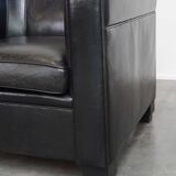 Very comfortable black Art Deco design armchair, made of sheepskin leather