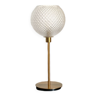 Table lamp with a large old globe and a golden foot